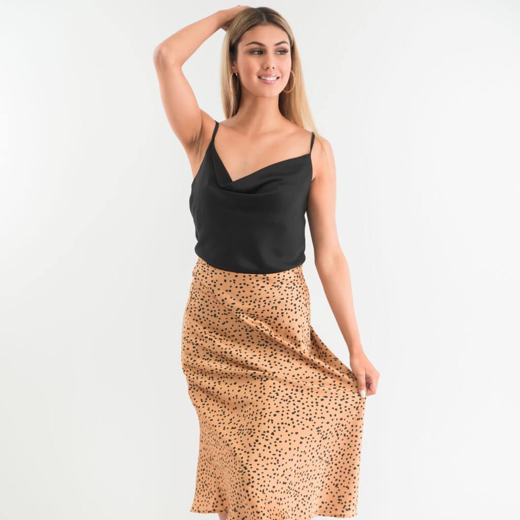 Headshot photography in Melbourne featuring a model in a black top and tan leopard print skirt