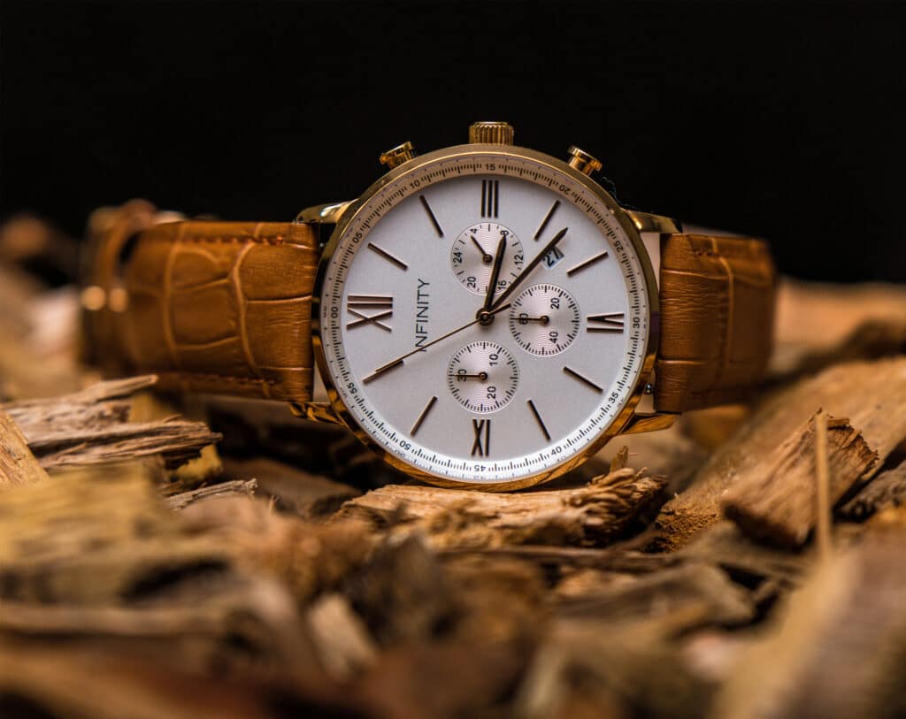 A stylish watch resting on a stack of wood - a perfect blend of elegance and nature's beauty
