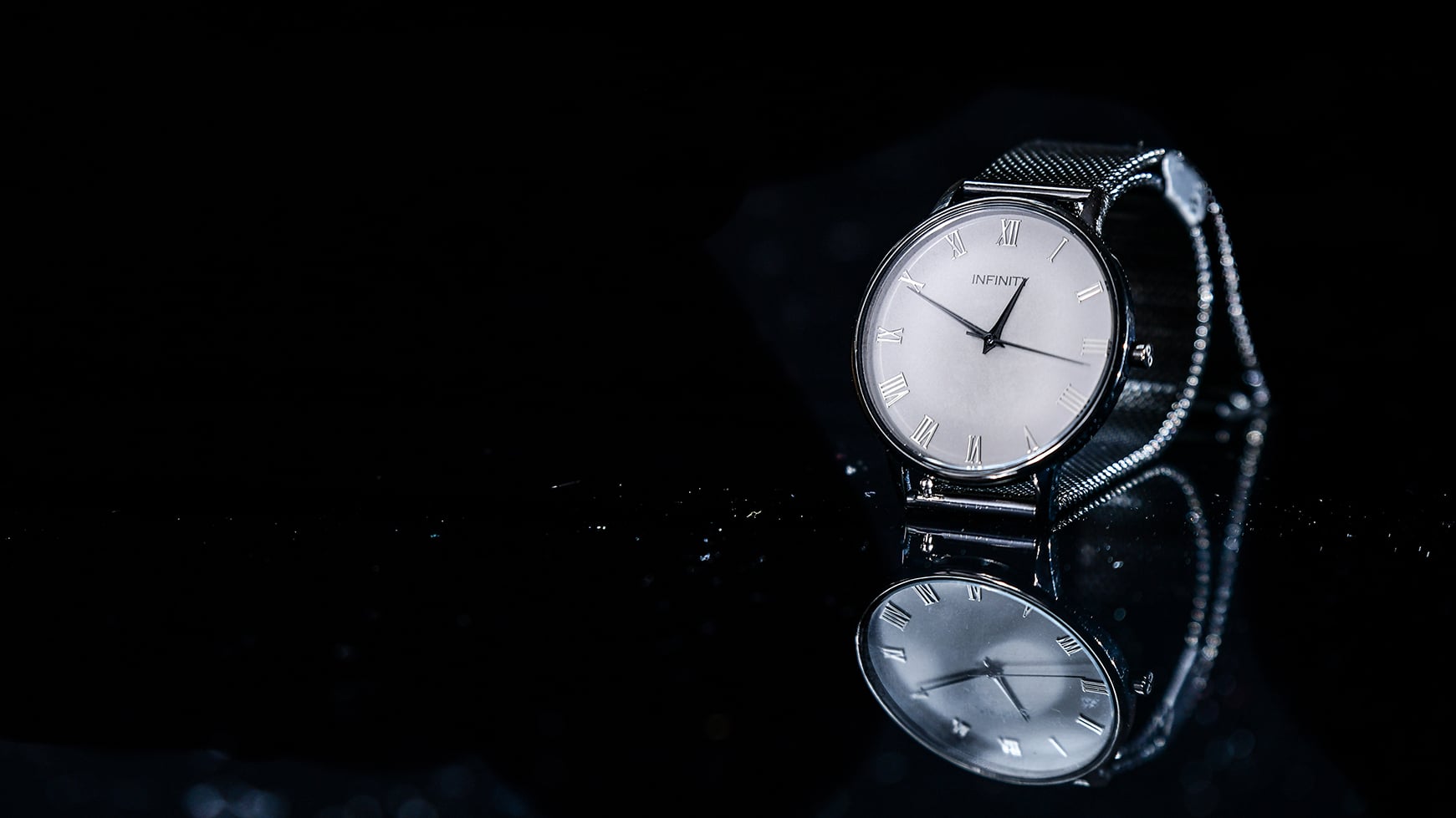 A watch reflected in water on a black background. Professional Product Photography Melbourne.