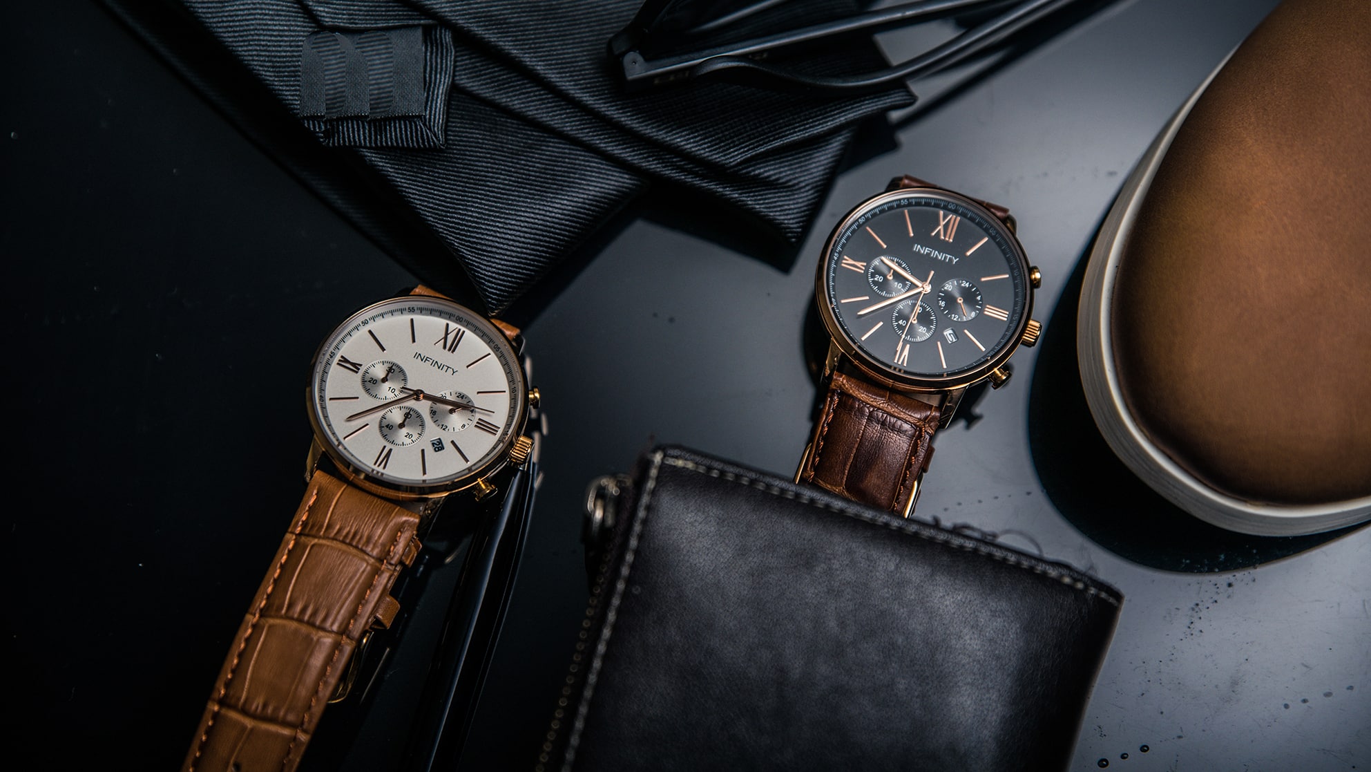 Three watches and a pair of shoes on a black surface. Professional Product Photography Melbourne.
