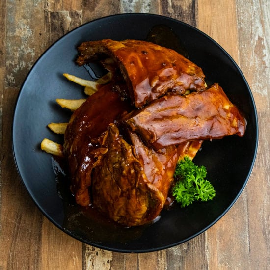 A mouthwatering plate of ribs and fries, captured by a Professional Brand Promo Photographer in Melbourne.