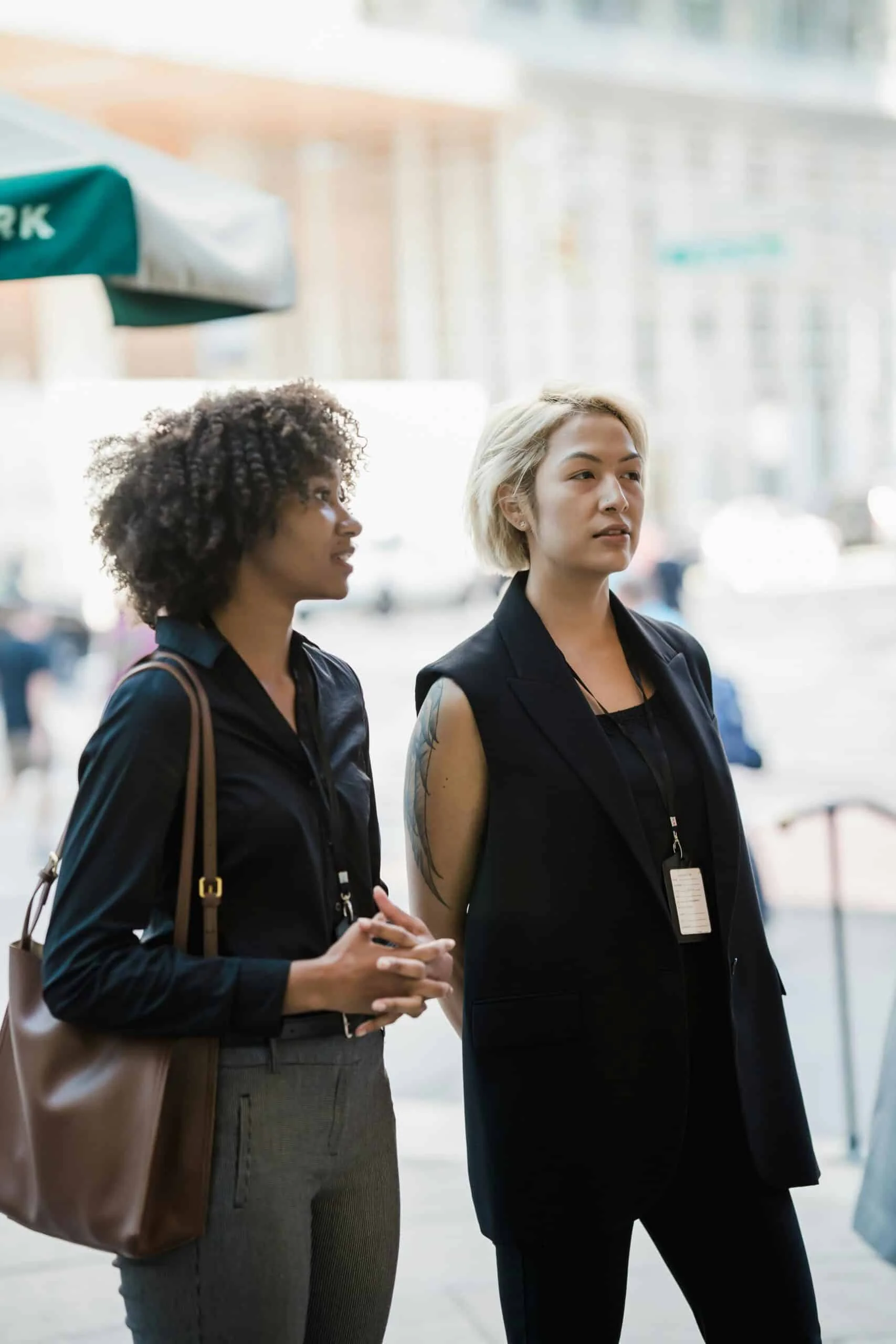 Elegantly Dressed Women Standing Outdoors and Talking
